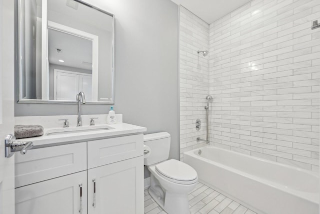 full bathroom with tile patterned flooring, vanity, toilet, and tiled shower / bath