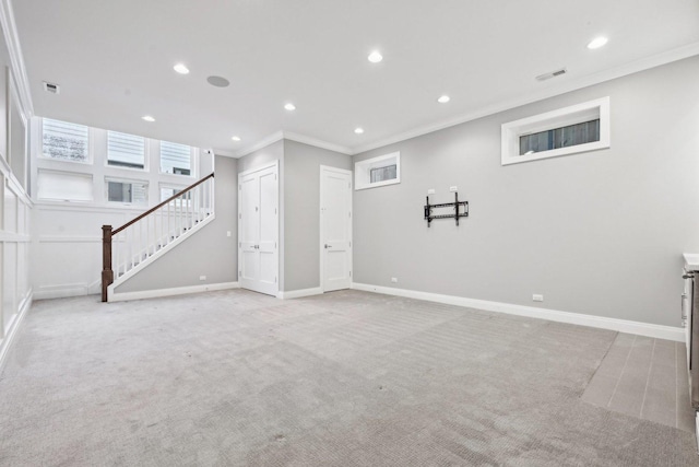 basement featuring light carpet and ornamental molding