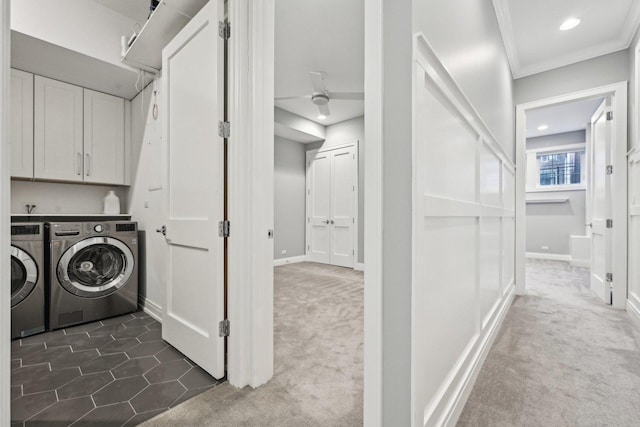 washroom with dark colored carpet, ornamental molding, washing machine and dryer, and cabinets