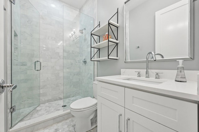 bathroom with vanity, toilet, and an enclosed shower