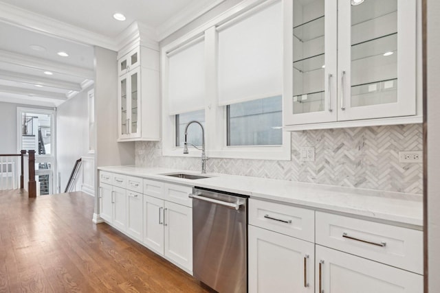 kitchen with light stone countertops, dishwasher, sink, beamed ceiling, and white cabinets