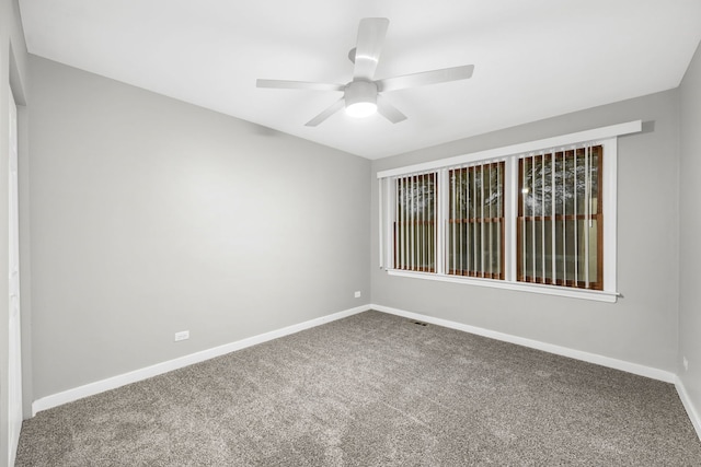 empty room with ceiling fan and carpet floors