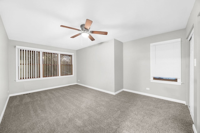 carpeted spare room with ceiling fan and a healthy amount of sunlight