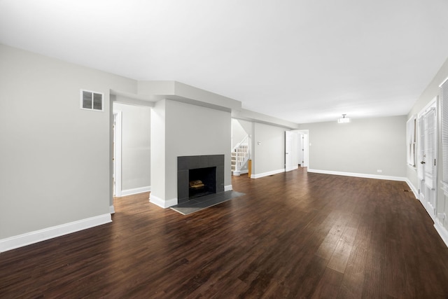 unfurnished living room with a fireplace and dark hardwood / wood-style flooring