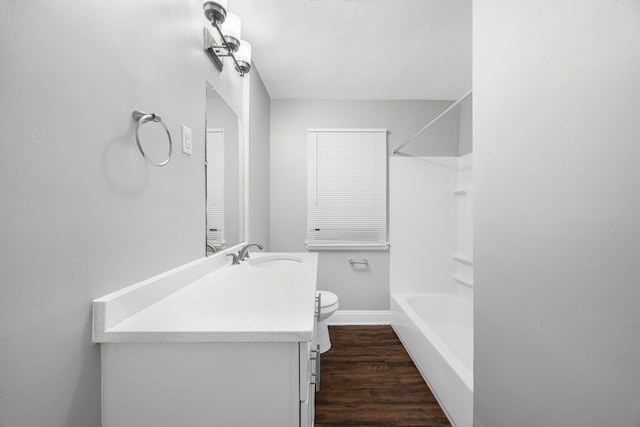 full bathroom featuring hardwood / wood-style floors, vanity, toilet, and shower / washtub combination