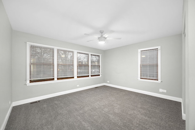 carpeted empty room featuring ceiling fan