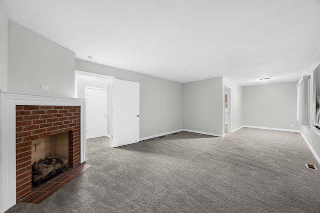 unfurnished living room with a fireplace and dark carpet