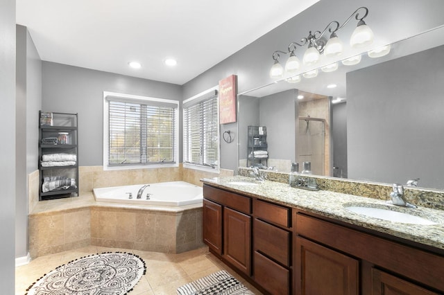 bathroom featuring tile patterned flooring, vanity, and plus walk in shower