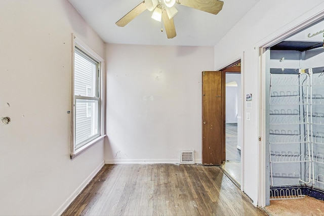 empty room featuring ceiling fan and wood-type flooring