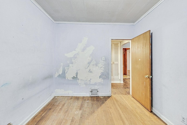 unfurnished room featuring light hardwood / wood-style flooring and ornamental molding