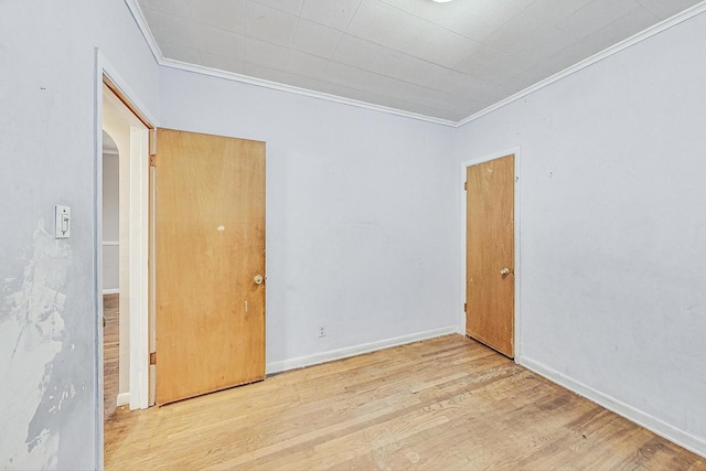 spare room with light hardwood / wood-style flooring and ornamental molding