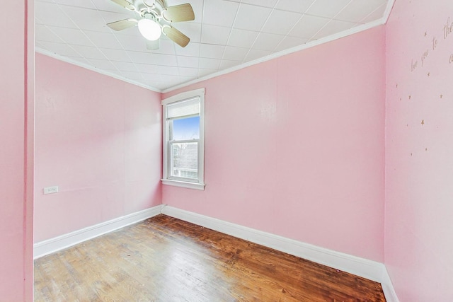 empty room with ceiling fan, wood-type flooring, and crown molding