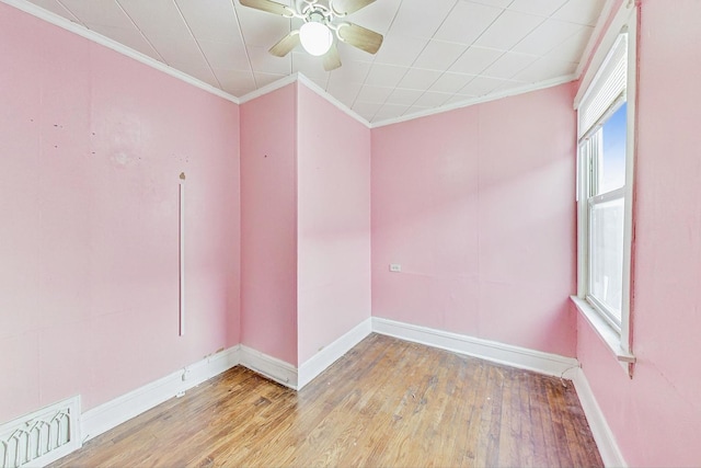 unfurnished room featuring ceiling fan, crown molding, and light hardwood / wood-style flooring