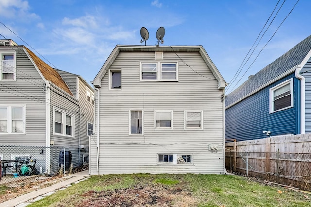 rear view of house featuring a yard