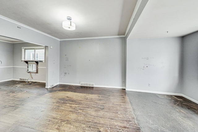 spare room featuring dark hardwood / wood-style floors and ornamental molding