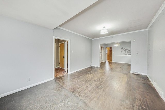 spare room featuring hardwood / wood-style floors and ornamental molding