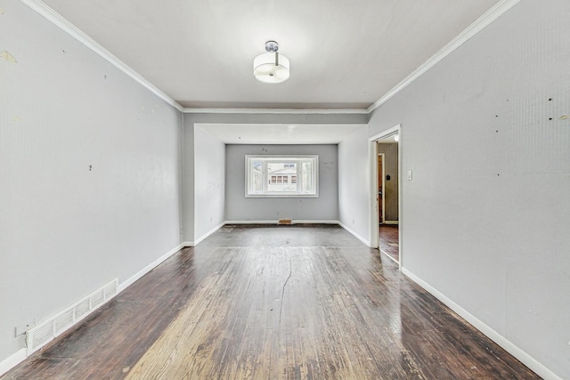 spare room featuring dark hardwood / wood-style flooring and crown molding