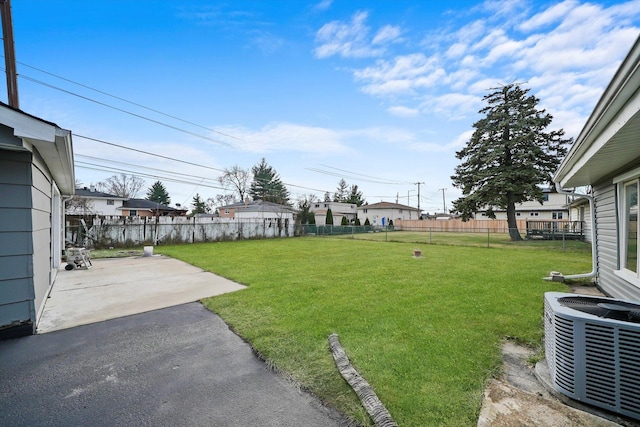 view of yard with central AC unit and a patio area