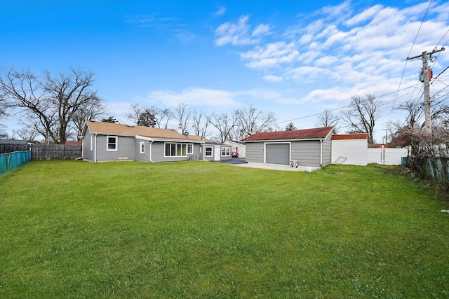 back of property with a lawn, an outdoor structure, and a garage