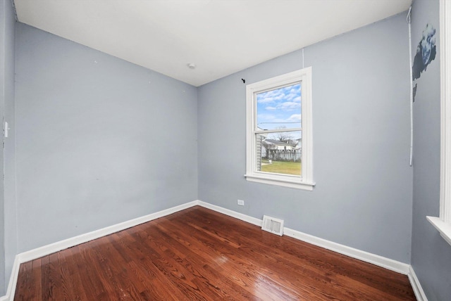 empty room with hardwood / wood-style floors