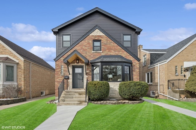 view of front of home featuring a front lawn and brick siding