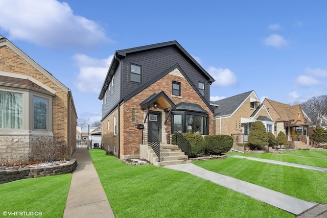 view of front of property with a front yard and brick siding