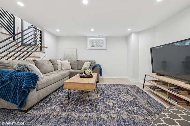 living room with baseboards, stairway, and recessed lighting