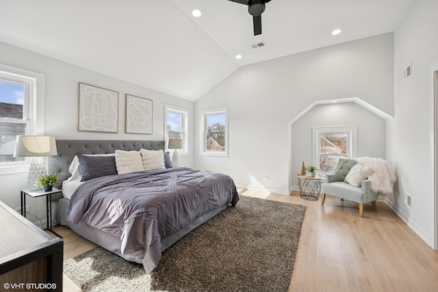 bedroom featuring vaulted ceiling, light wood-type flooring, visible vents, and baseboards