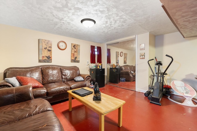 living room featuring concrete flooring and a textured ceiling