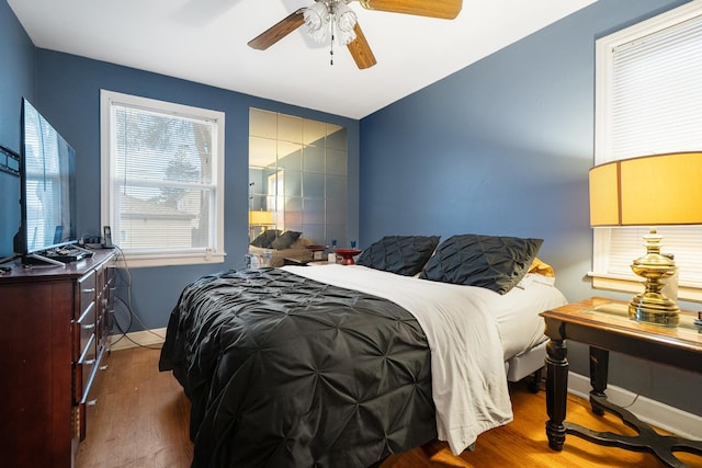 bedroom featuring ceiling fan and dark hardwood / wood-style floors