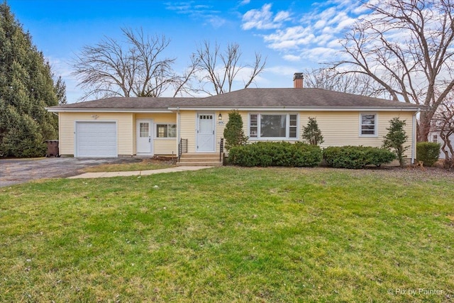 ranch-style home with a front yard and a garage