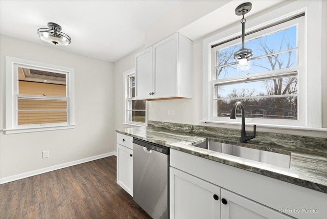 kitchen with dark wood-type flooring, white cabinets, sink, hanging light fixtures, and stainless steel dishwasher