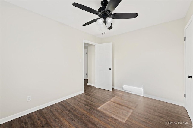 spare room featuring ceiling fan and dark hardwood / wood-style floors