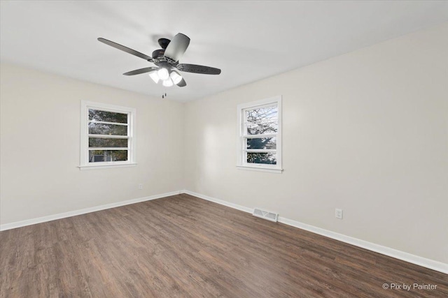 spare room with dark hardwood / wood-style floors and ceiling fan