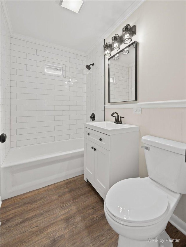 full bathroom featuring crown molding, vanity, wood-type flooring, and tiled shower / bath combo