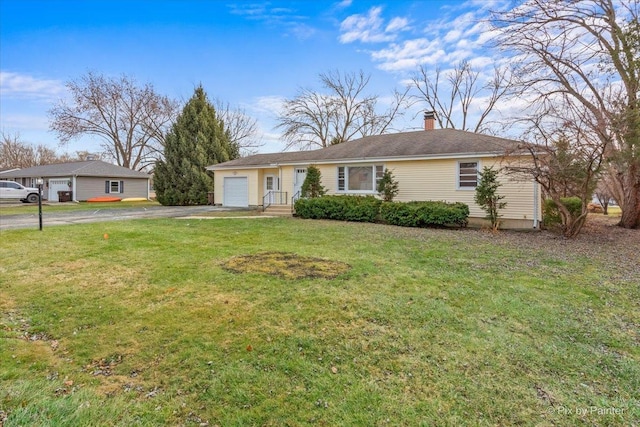 ranch-style house with a garage and a front lawn