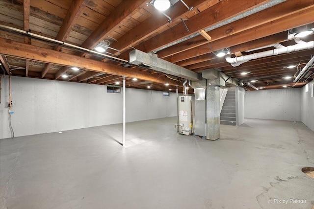 basement featuring heating unit and water heater