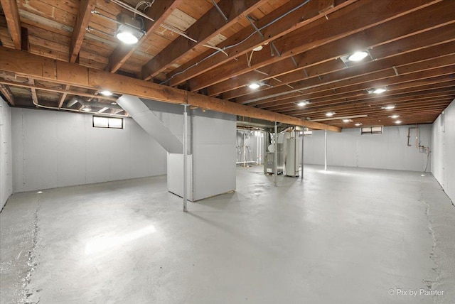 basement featuring heating unit and water heater