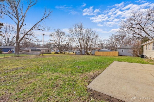 view of yard with central AC and a patio