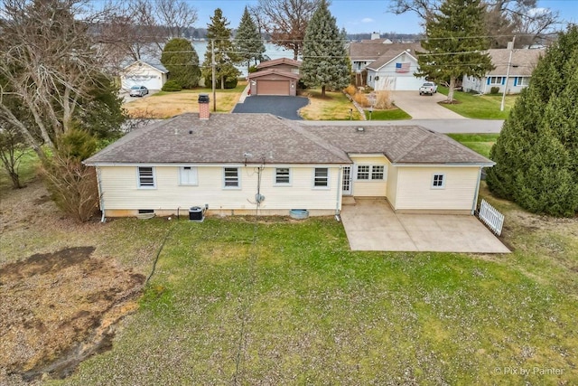 rear view of house featuring a patio area and a lawn