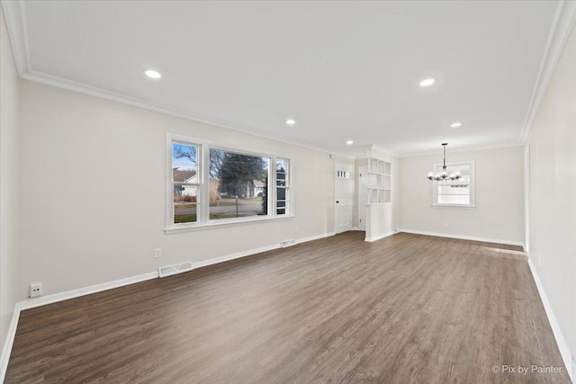 unfurnished living room with dark hardwood / wood-style flooring, crown molding, and an inviting chandelier