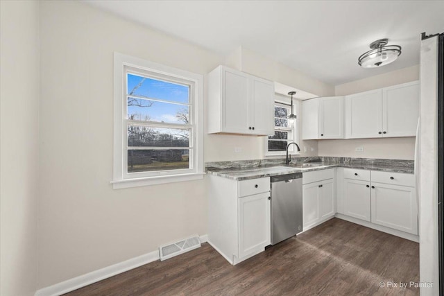 kitchen with stainless steel dishwasher, dark hardwood / wood-style flooring, and white cabinetry