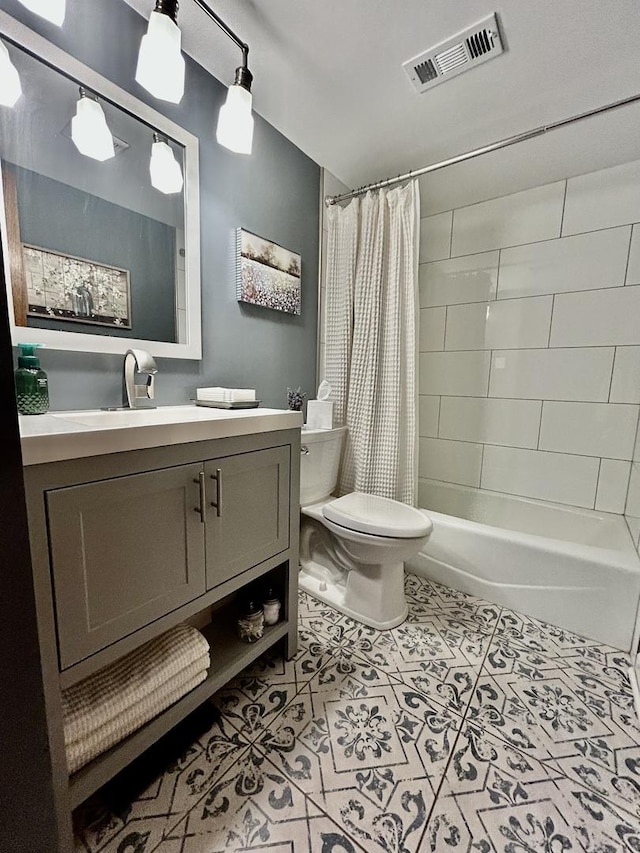 full bathroom with toilet, vanity, visible vents, tile patterned floors, and shower / bath combo