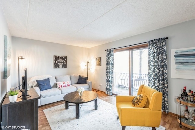 living room with a textured ceiling and wood finished floors