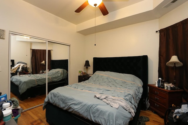 bedroom featuring wood-type flooring, a closet, and ceiling fan