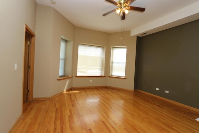 spare room featuring ceiling fan and light wood-type flooring