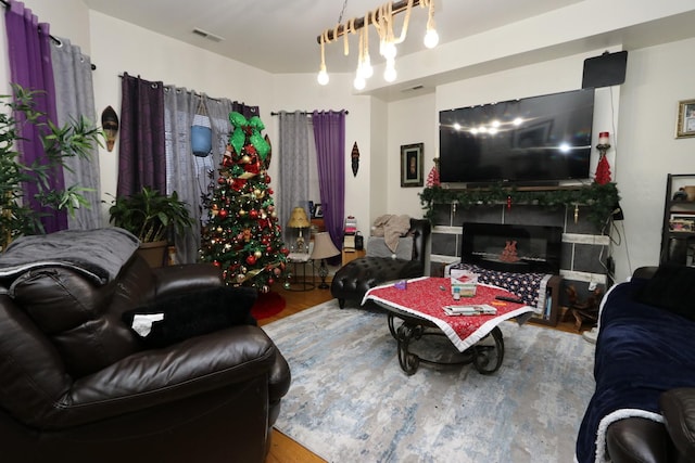 living room featuring wood-type flooring and a fireplace