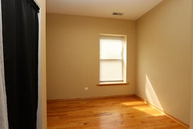 spare room with light hardwood / wood-style floors