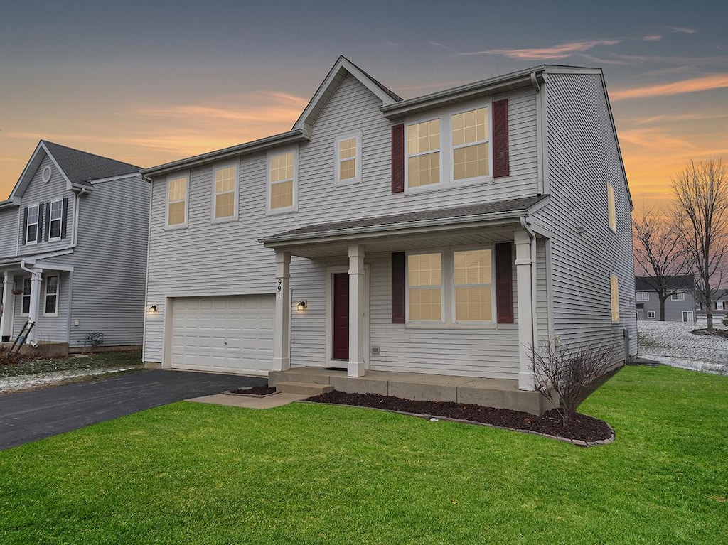 view of front of property with a lawn and a garage