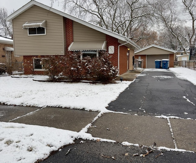 view of front facade featuring a garage and an outbuilding